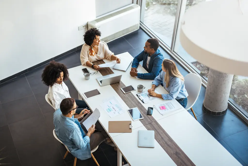 At 50 people, standardize how work moves between teams so tools do not create new silos